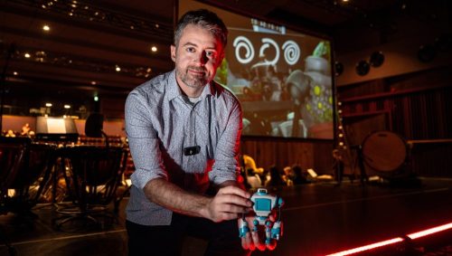 Weekend Marking: XX Vickie Maye: 13/02/25  Acclaimed comic book artist and Marvel animator Will Sliney pictured holding a figurine based on his new short as the orchestra at the Cork school of music records the live soundtrack for the animation in the background. picture Chani Anderson