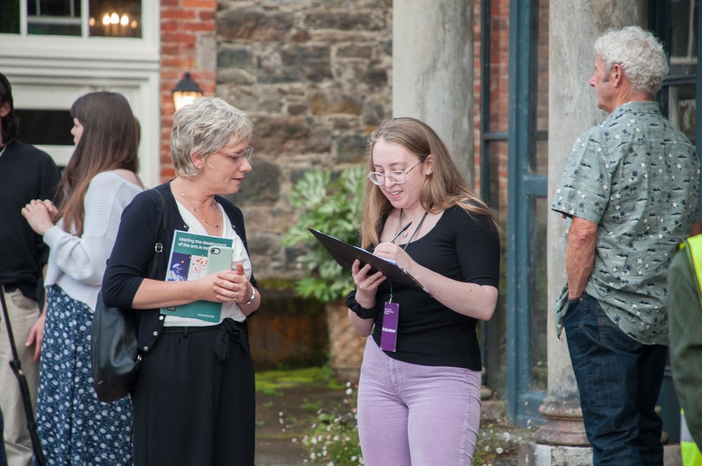 Volunteer taking audience surveys