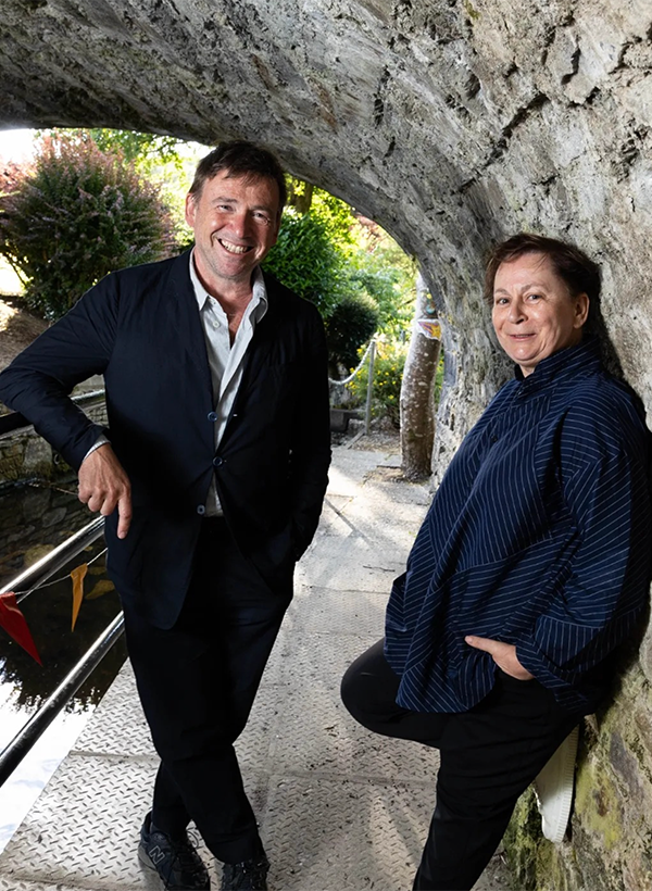 Man and woman standing under bridge