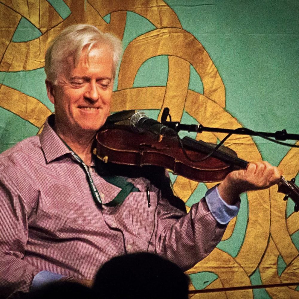 A photo of Brian Conway playing the fiddle