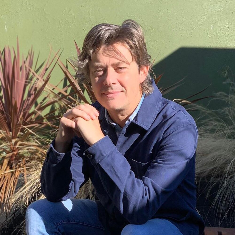 Photo of author and illustrator Peter Donnolly seated on an outdoor bench|